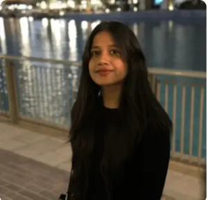 Smiling woman posing outdoors at night