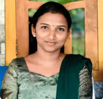 Woman in green dress smiling indoors