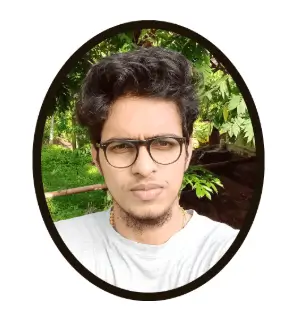 Young man with glasses in outdoor greenery background