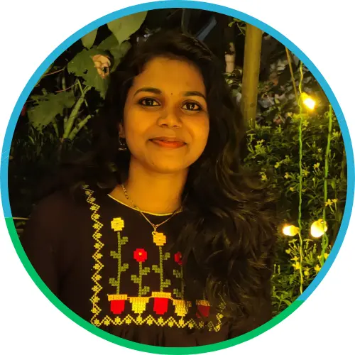 Portrait of a smiling young woman in traditional attire, captured under warm lighting with a natural leafy background, framed in a circular design
